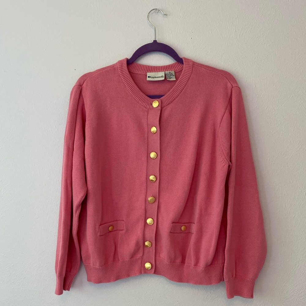 Super cute pink sweater with gold buttons.